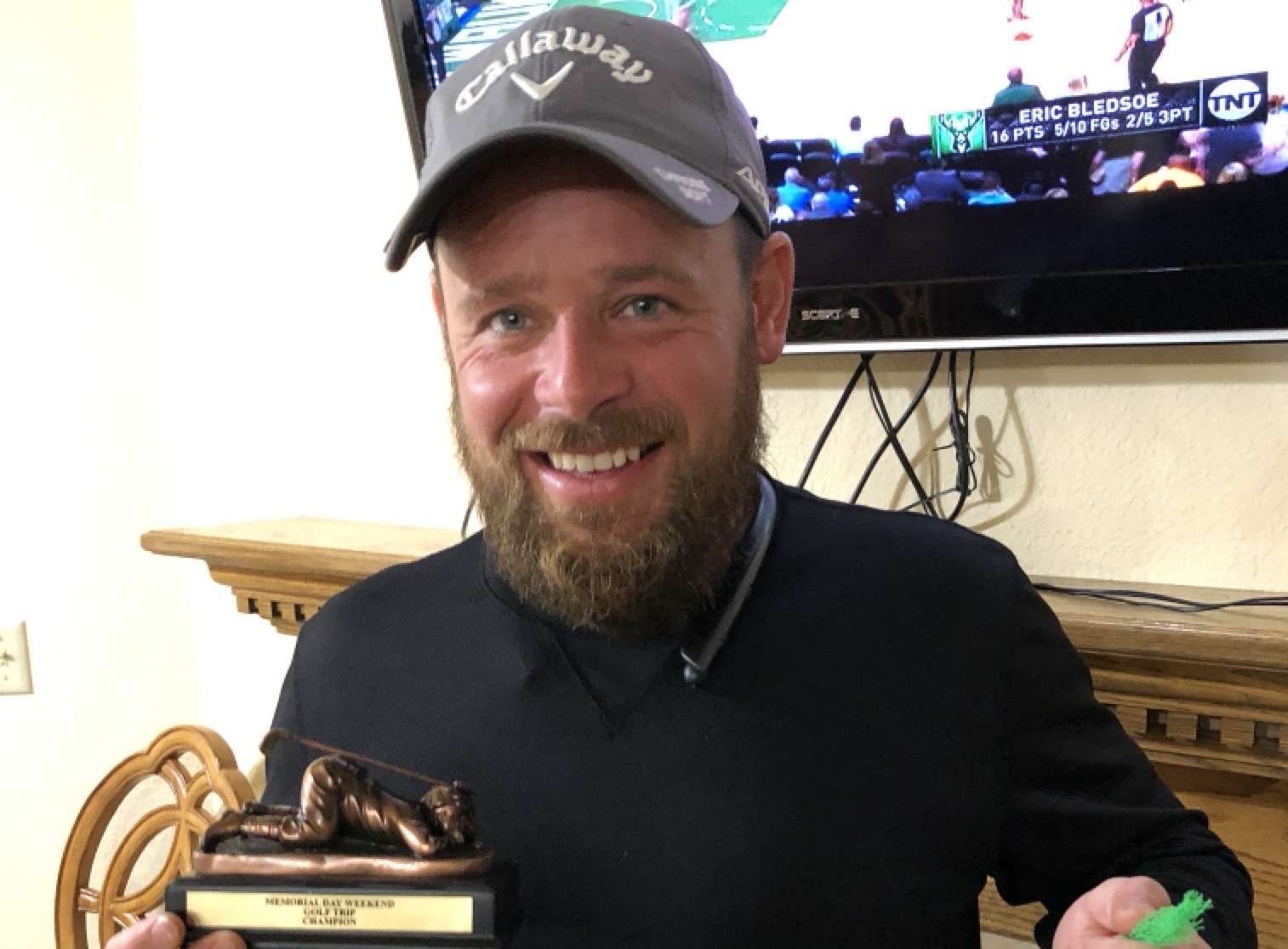 Tom Seaborg holding a champion gift commemorating his inaugural trip win