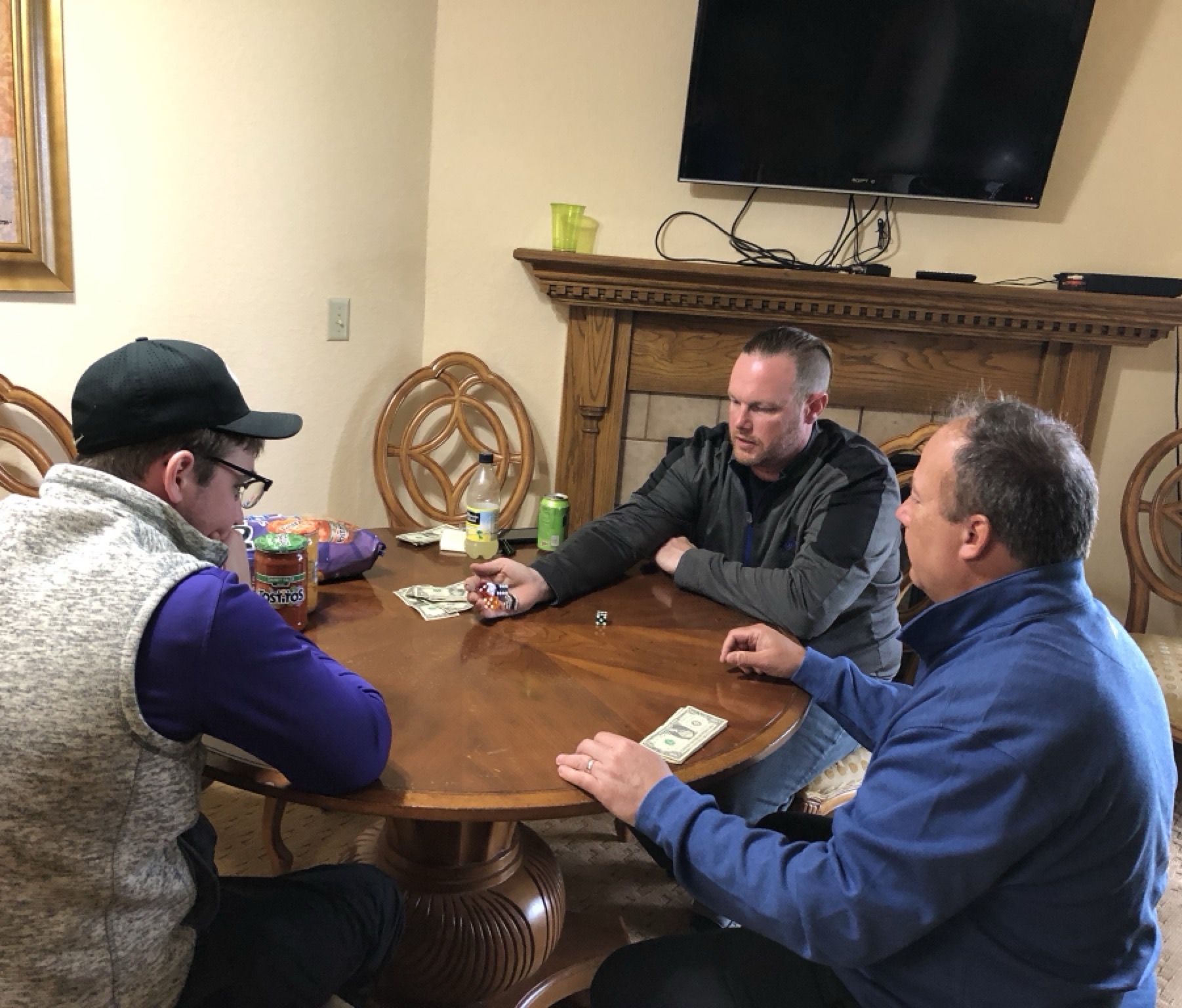 Bob Sieloff sitting at the table playing a game with reading glasses on