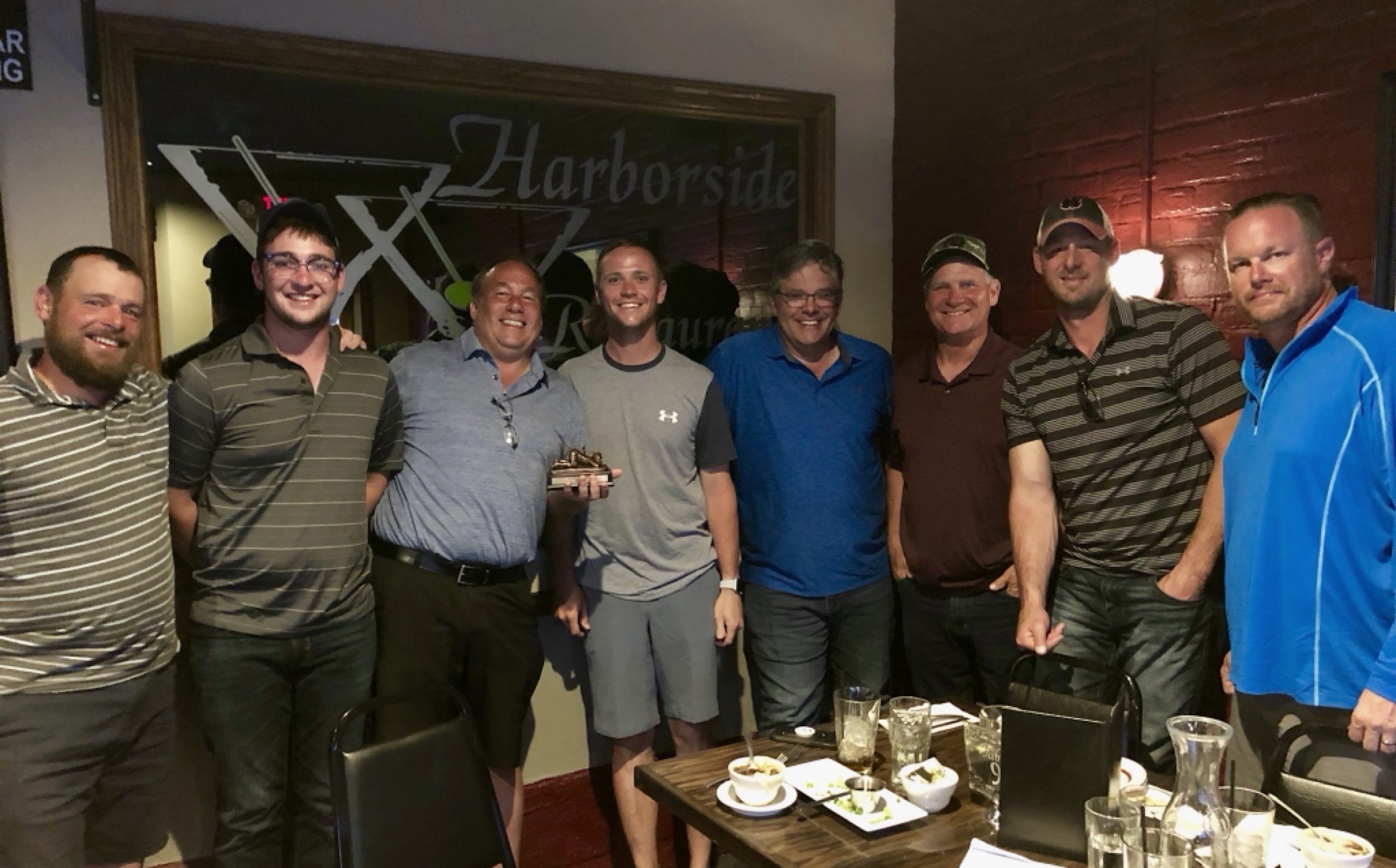 Group photo at Harborside with Bob Sieloff holding the trophy
