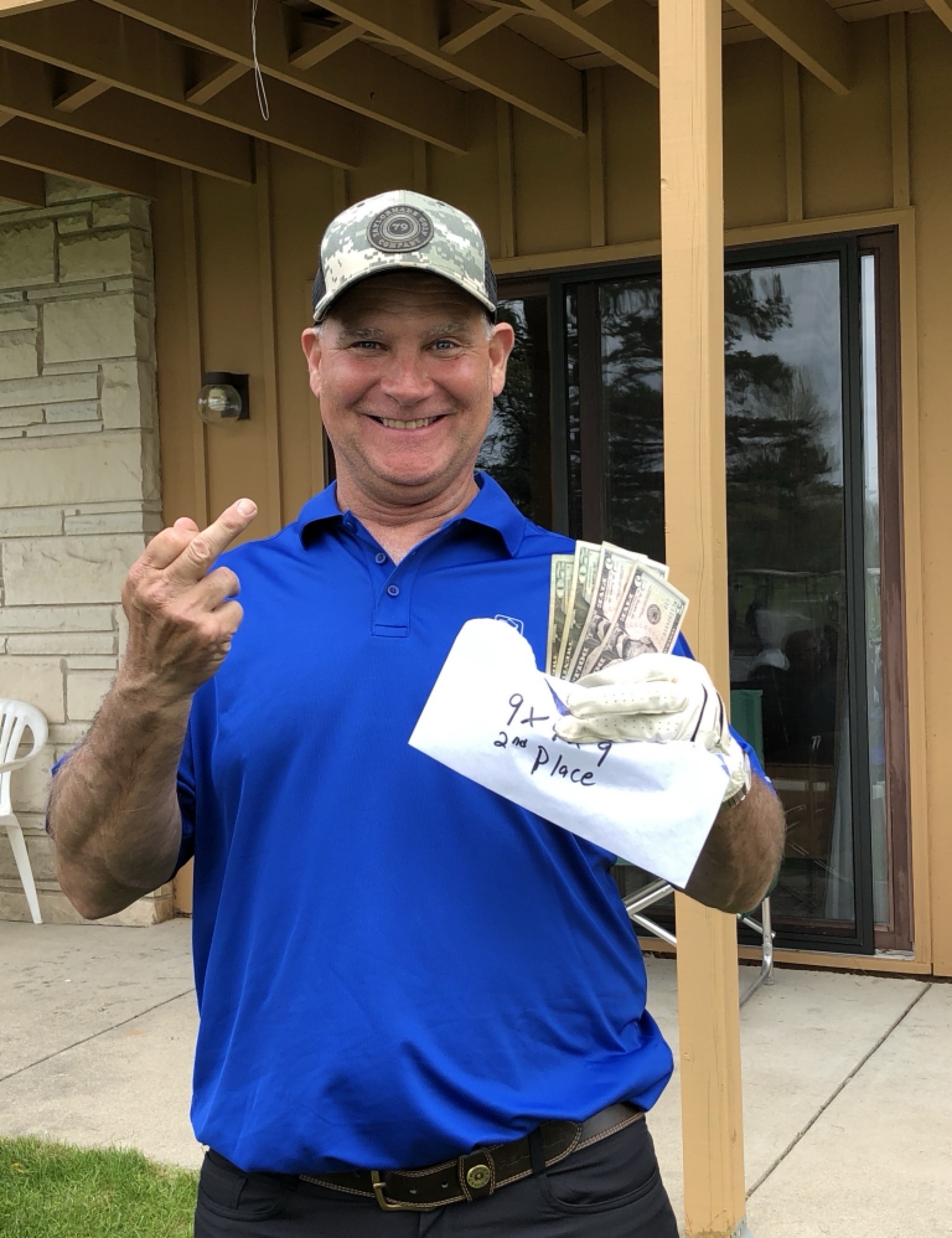 Bryan holding up his winnings in his signature pose