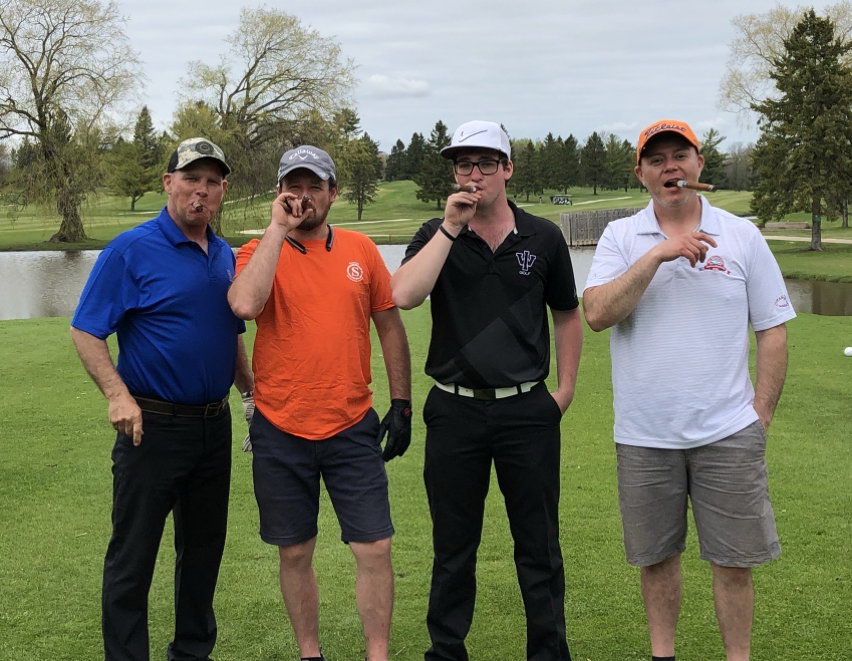 Group smoking cigars laughing together